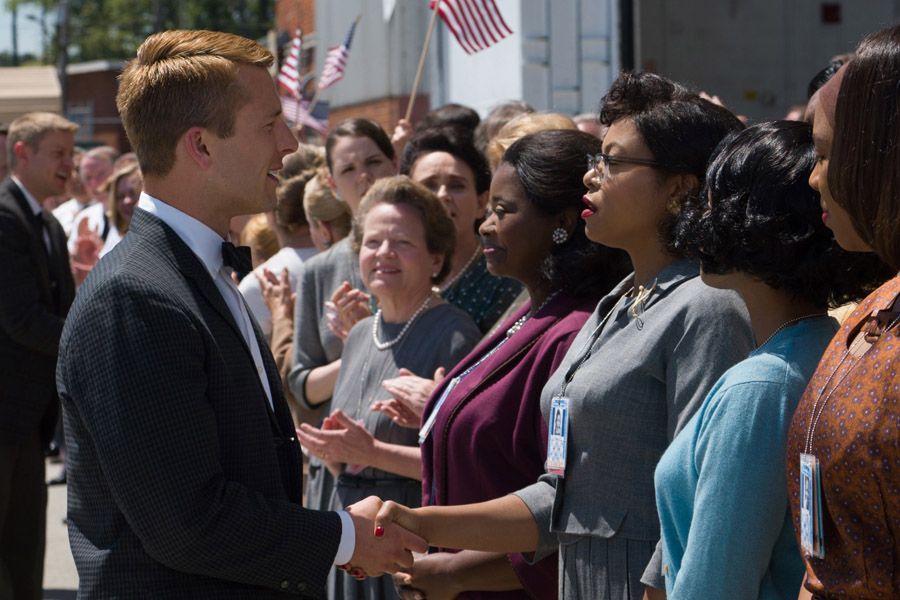 Katherine G. Johnson (Taraji P. Henson) in gray, flanked by fellow mathematicians Dorothy Vaughan (Octavia Spencer), left, and Mary Jackson (Janelle Mone), meets the man they helped send into orbit, John Glenn (Glen Powell) in the upcoming movie Hidden Figures.  Photograph: Hopper Stone/SMPSP/Twentieth Century Fox.